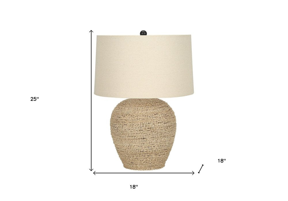 25" Beige Rattan Round Table Lamp With Beige Drum Shade. Table lamp isolated on a plain white background, in a beige rattan finish.