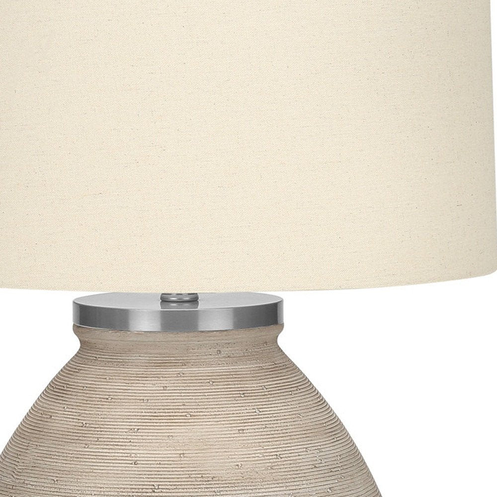 25" Cream Concrete Round Table Lamp With Beige Drum Shade. Table lamp in cream.