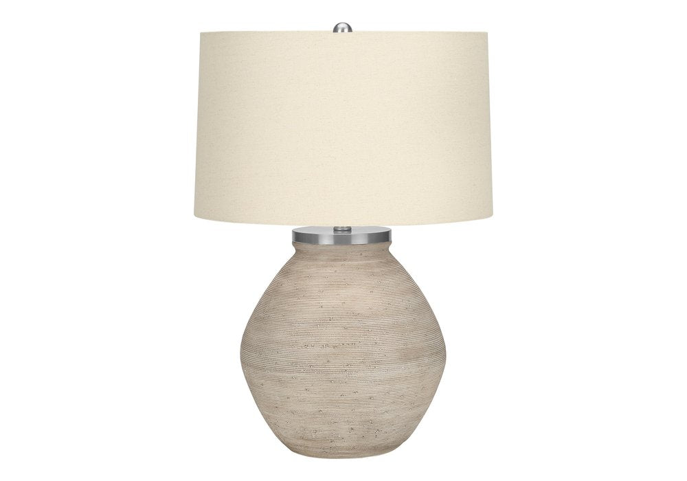 25" Cream Concrete Round Table Lamp With Beige Drum Shade. Table lamp isolated on a plain white background, showing its cream color.