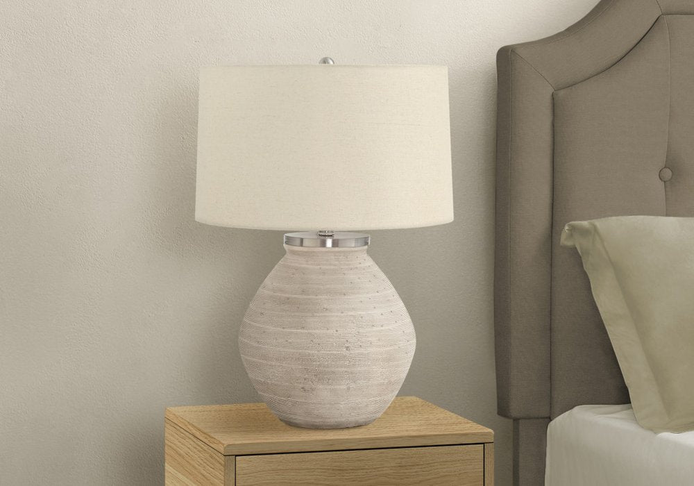 Detail view of 25" Cream Concrete Round Table Lamp With Beige Drum Shade, filling the frame with the cream texture.
