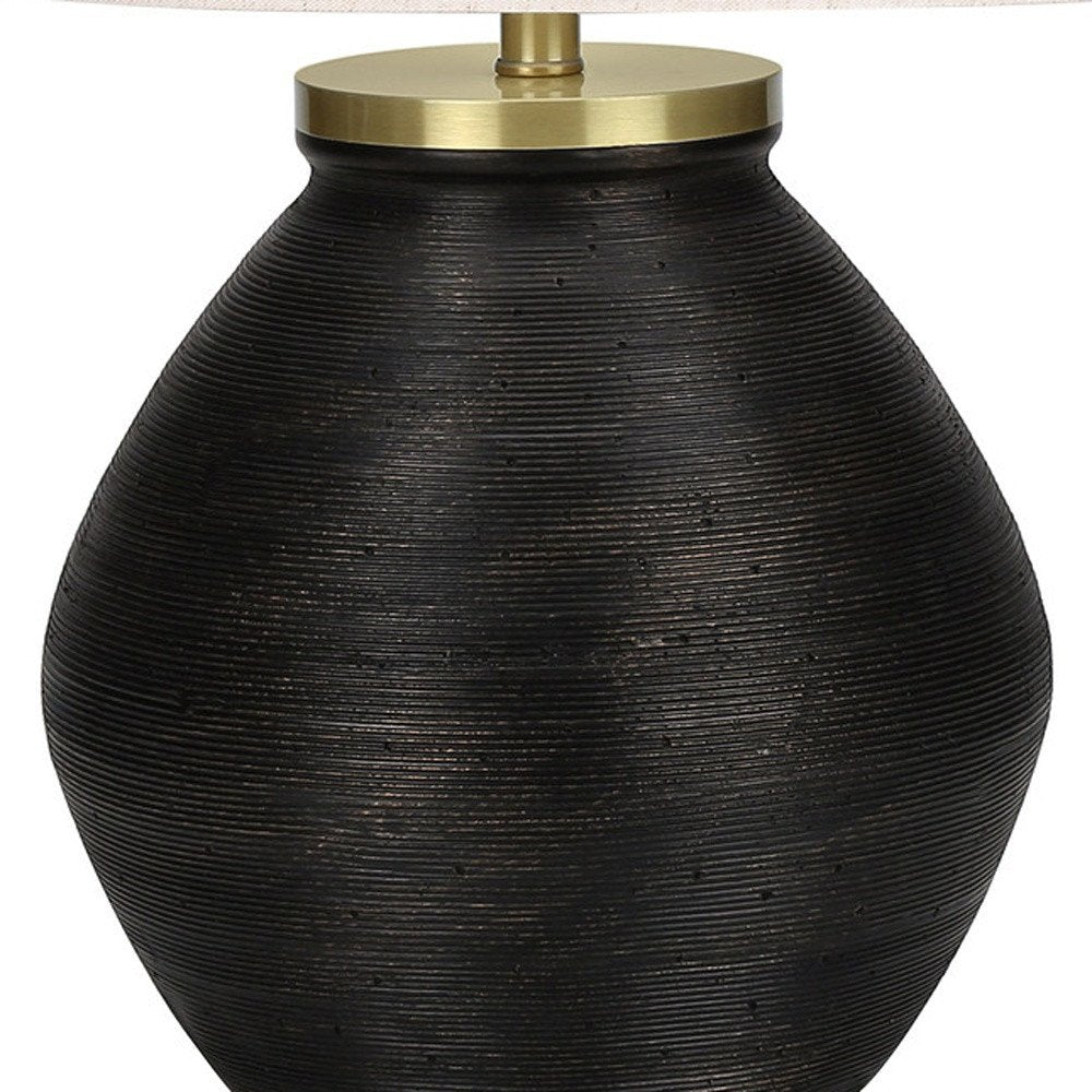 25" Black and Gold Concrete Round Table Lamp With Ivory Drum Shade. Table lamp isolated on a plain white background, finished in gold.