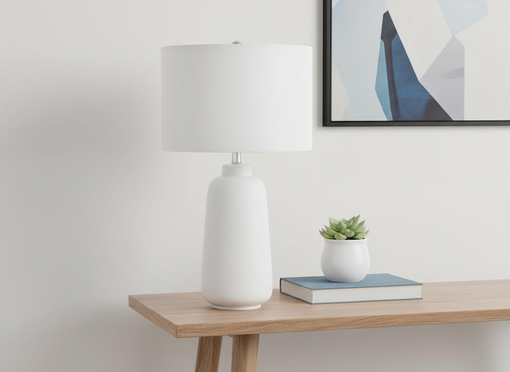 26" Cream Ceramic Cylinder Table Lamp With Cream Drum Shade. Table lamp isolated on a plain white background, finished in cream ceramic.