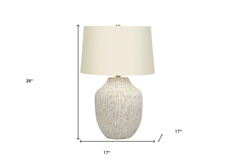 26" Cream Ceramic Round Table Lamp With Cream Empire Shade. Table lamp isolated on a plain white background, showing a cream ceramic surface.
