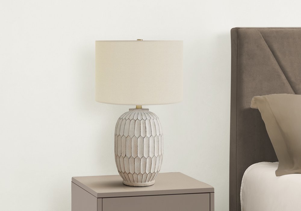 Cropped view of 24" Cream Geometric Table Lamp With Cream Drum Shade focusing on the cream surface.