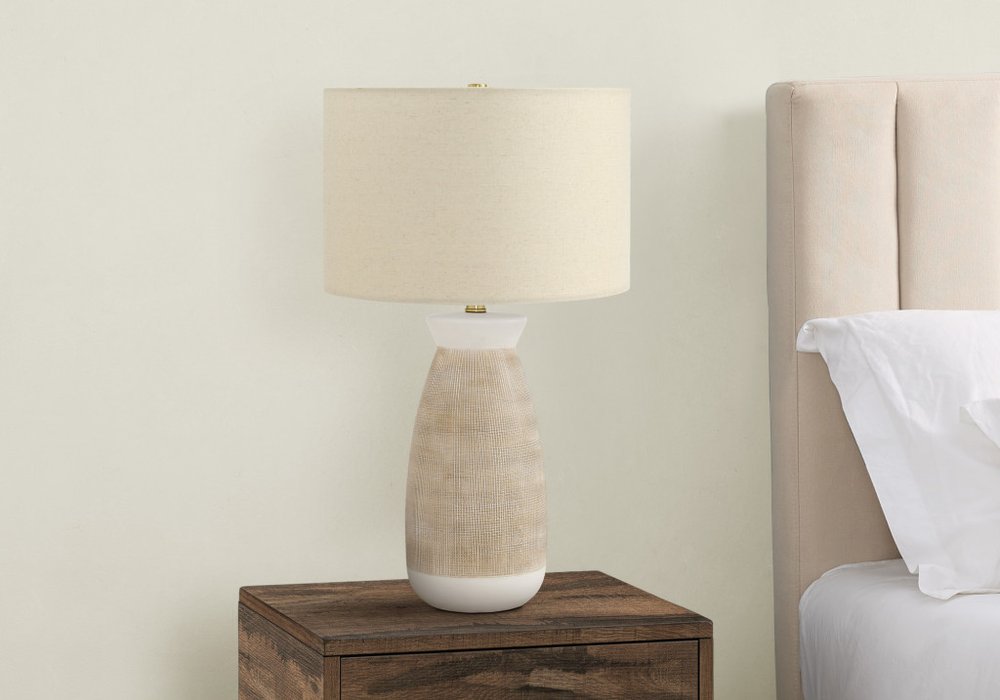 27" Brown and White Ceramic Round Table Lamp With Beige Drum Shade. Table lamp isolated on a plain white background, in a beige ceramic finish.