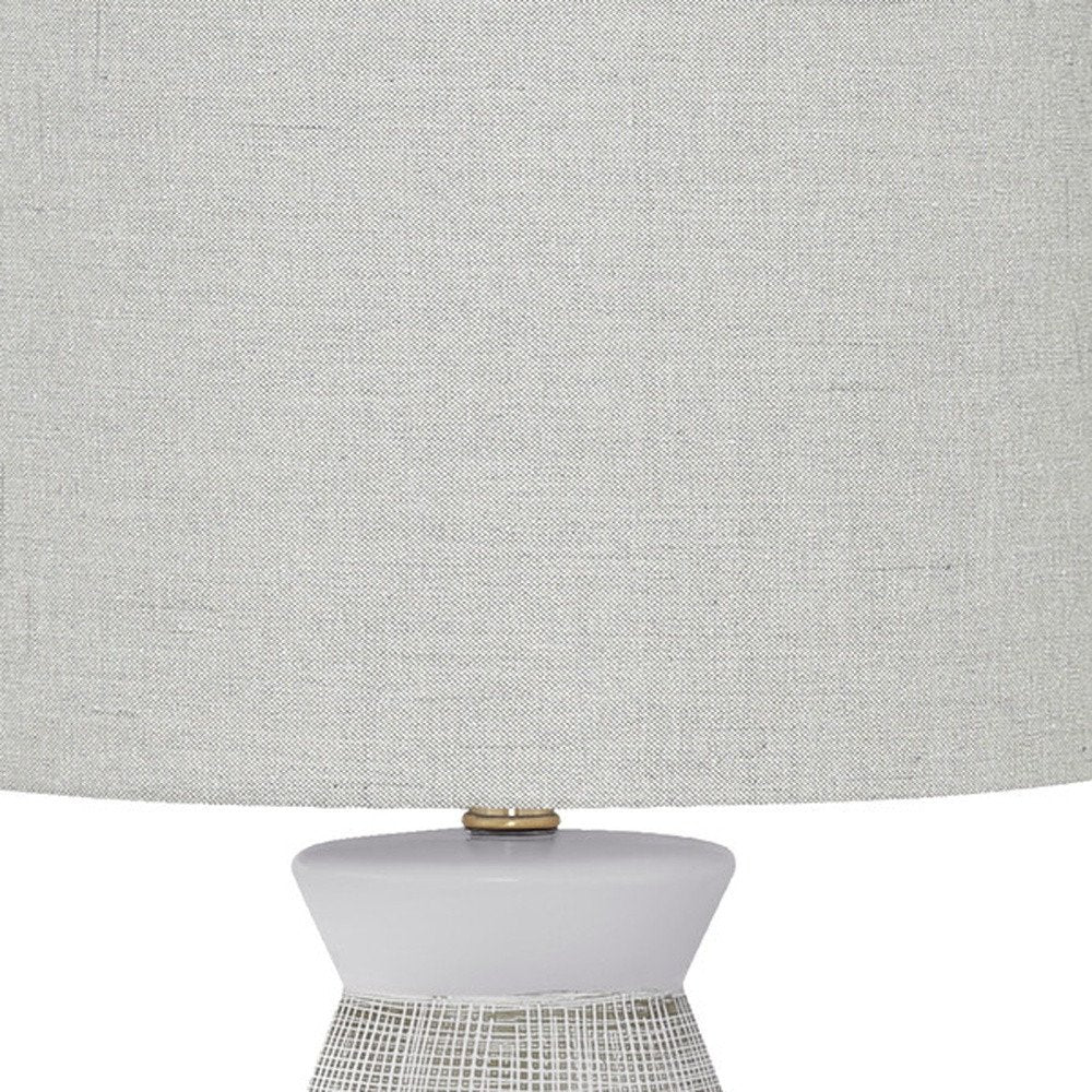 Cropped view of 27" Gray and White Ceramic Round Table Lamp With Gray Drum Shade focusing on the white ceramic surface.