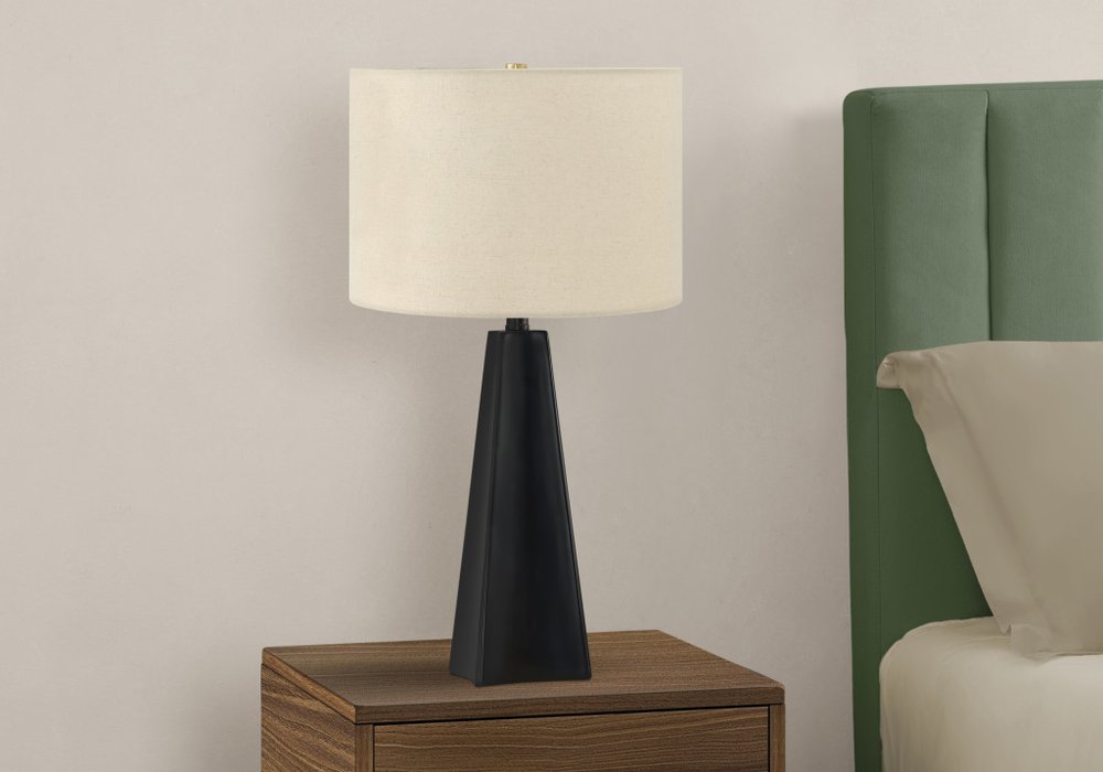 27" Black Geometric Table Lamp With Beige Drum Shade. Table lamp isolated on a plain white background, showing its beige color.
