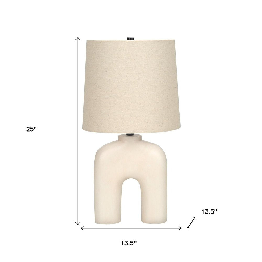 25" Cream Geometric Table Lamp With Beige Empire Shade. Table lamp isolated on a plain white background, showing its cream color.