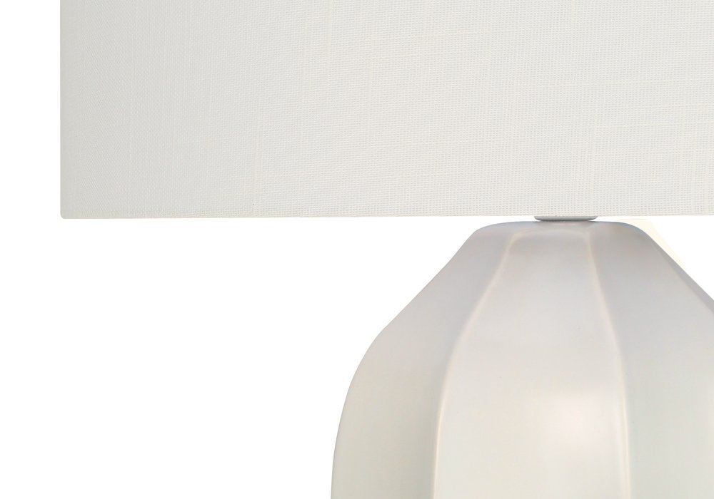 27" Cream Ceramic Geometric Table Lamp With Cream Drum Shade. Table lamp isolated on a plain white background, finished in cream ceramic.