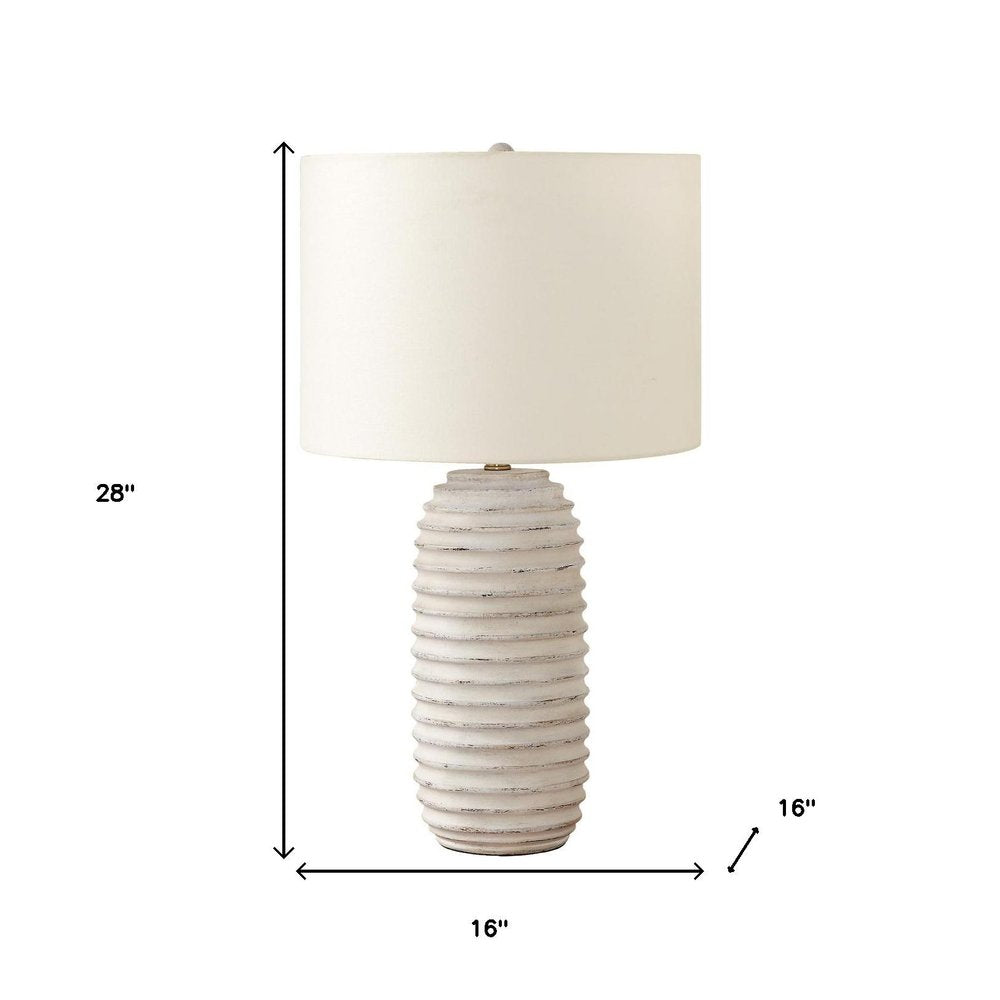 28" Cream Geometric Table Lamp With Cream Drum Shade. Table lamp isolated on a plain white background, finished in cream.