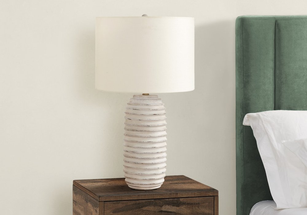 28" Cream Geometric Table Lamp With Cream Drum Shade. Table lamp isolated on a plain white background, in a cream finish.