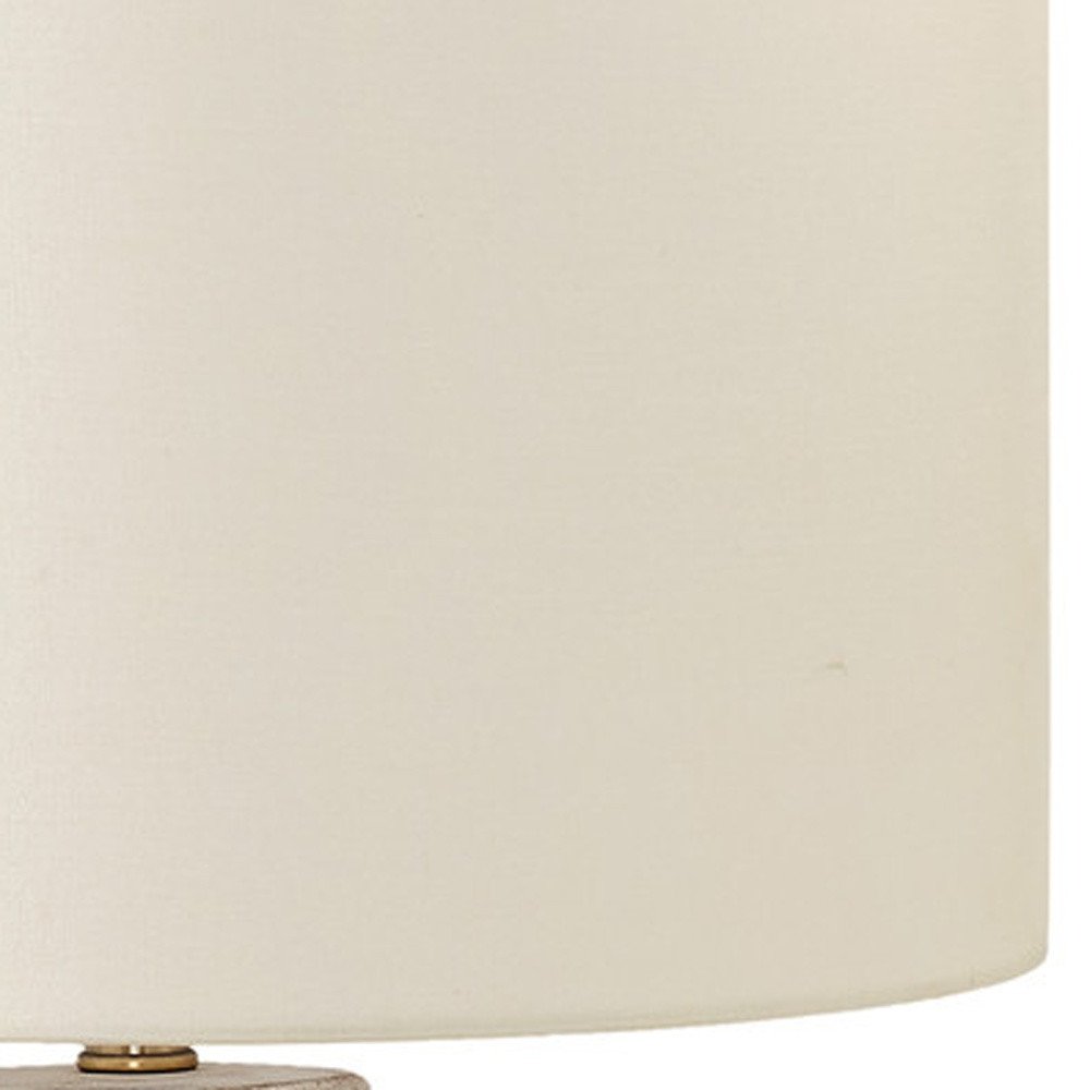 Detail view of 28" Cream Geometric Table Lamp With Cream Drum Shade, filling the frame with the cream texture.