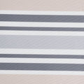 A striped pet bed with tan, gray, and white horizontal stripes.