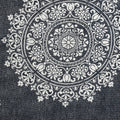 24" X 36" Stonewashed Blue Medallion Pillow Style Pet Bed With Removable Cover styled in a furnished interior with a dark wall on a charcoal floor.