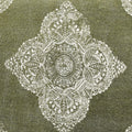 A green pet bed with a white medallion pattern, made of stonewashed fabric, with a removable cover.