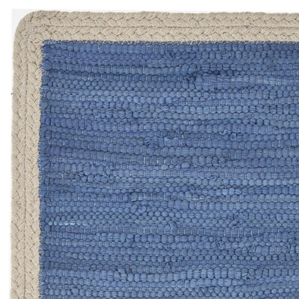 19" Set of Four Blue And Natural Solid With Border Cotton Placemats close-up highlighting the tan linen surface.