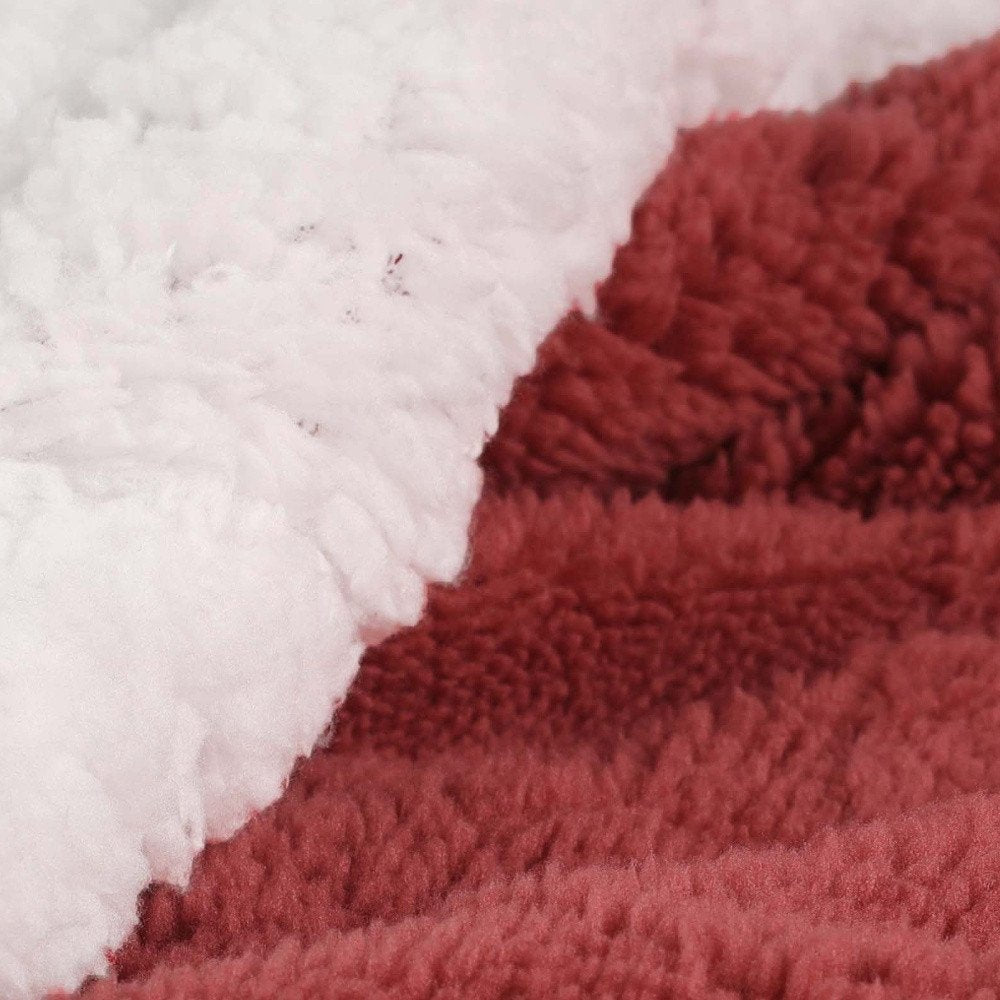 Twin Red And Orange Fleece Knitted Plush Blanket in a home interior