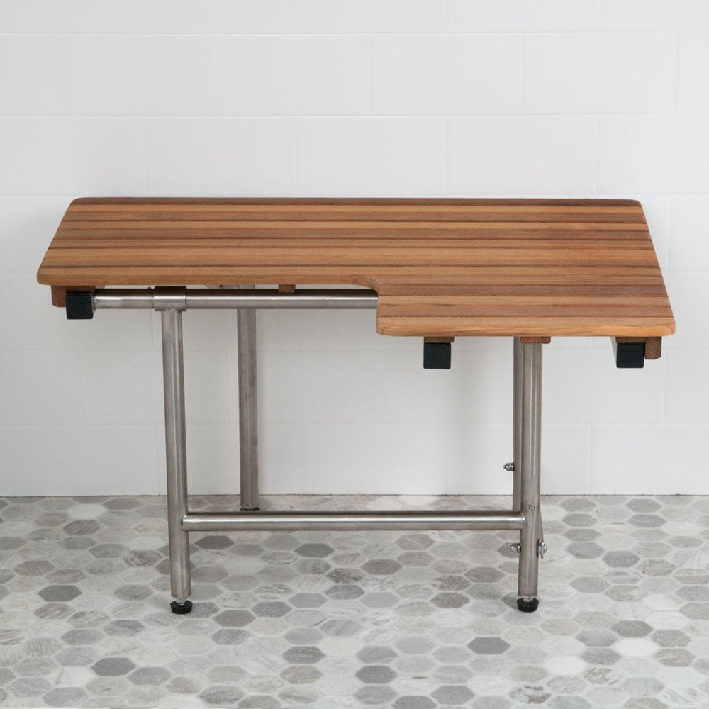 Brown teak shower bench with stainless steel legs mounted on a white tiled wall and grey hexagonal floor.