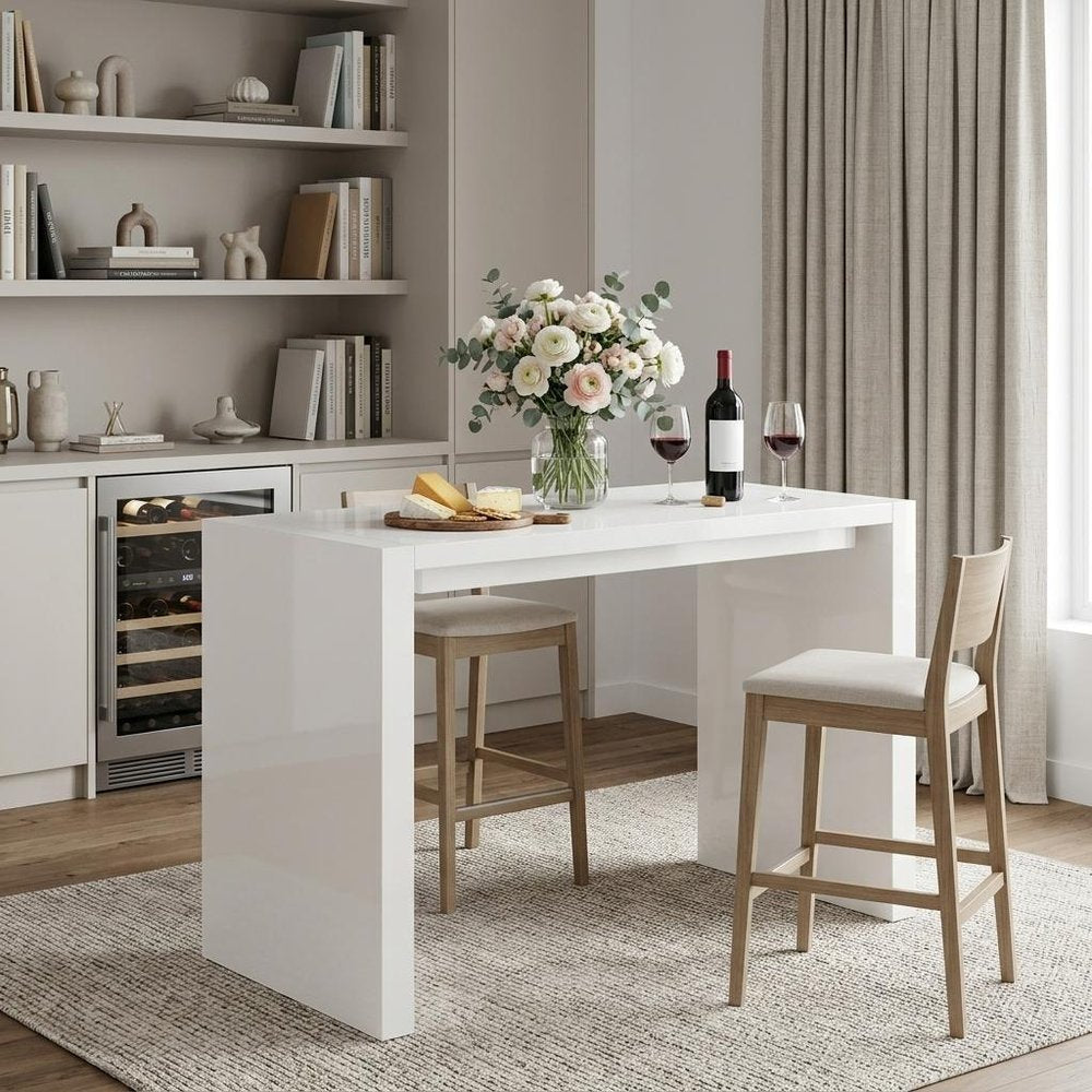 60" White Wood Rectangular Bar Height Bar Table styled in a furnished interior with a tan wall on a wood floor.