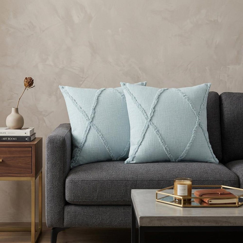 Set of Two Blue Diamond Cotton Throw Pillow With Fringe in a home interior