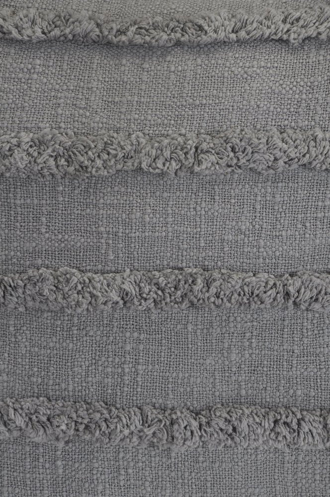 Close-up of two gray ribbed cotton throw pillows with fringe detail.
