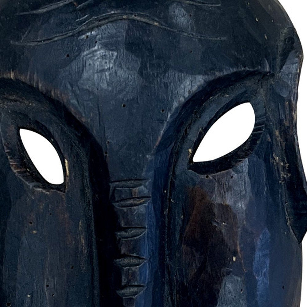 10" Black Solid Wood Decorative Mask Tabletop Sculpture photographed against a dark studio background in black.