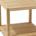 Close-up of a natural wood outdoor side table with slatted top and shelf, set against a white background.