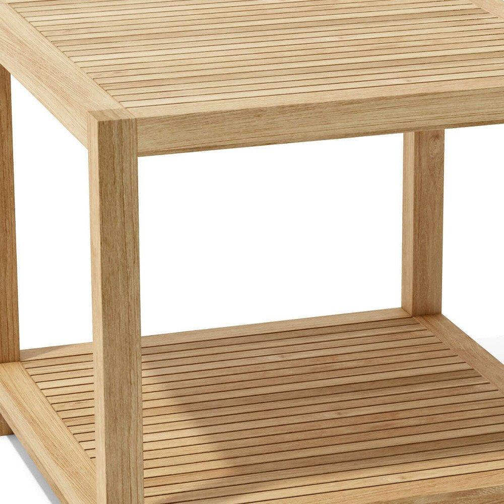 Close-up of a natural wood outdoor side table with slatted top and shelf, set against a white background.
