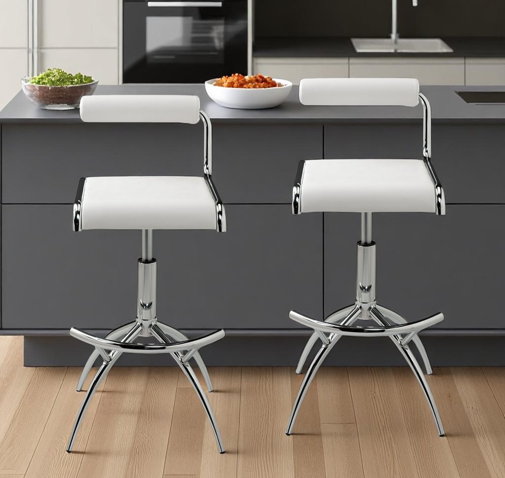 Set of Two White And Silver Faux Leather And Metal Low Back Adjustable Height Bar Chairs in a home interior