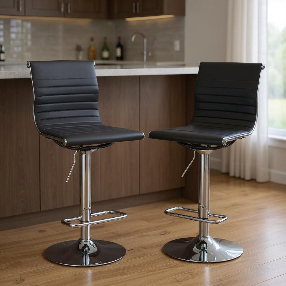 Set of Two Black And Silver Faux Leather And Metal Low Back Adjustable Height Bar Chairs in a home interior