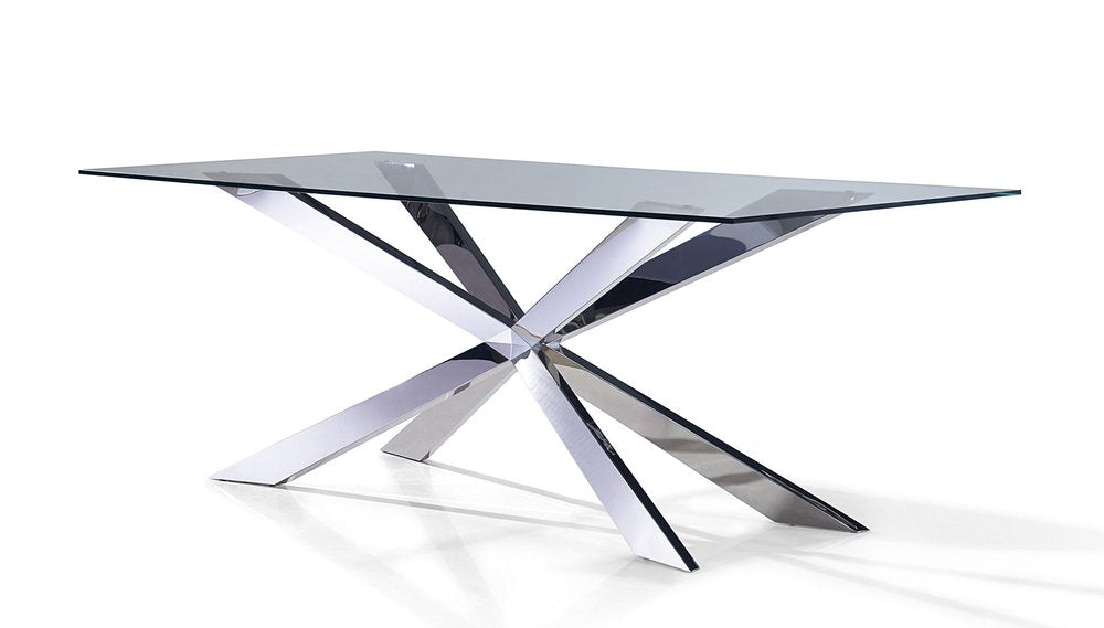 Glass top dining table with a silver metal cross leg base on a white background.