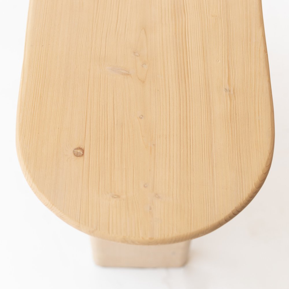 60" Natural Solid Wood Oval Console Table. Console table isolated on a plain white background, finished in tan wood.