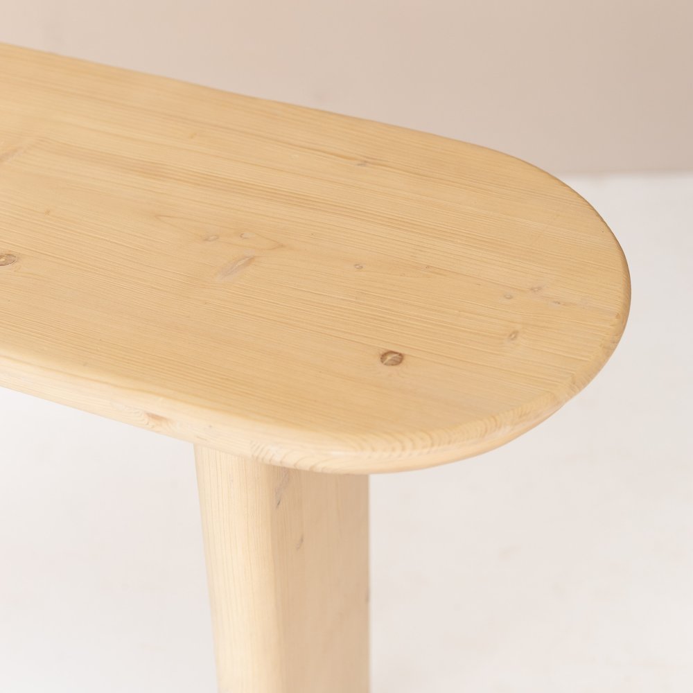 Close-up of 60" Natural Solid Wood Oval Console Table showing the tan wood texture.