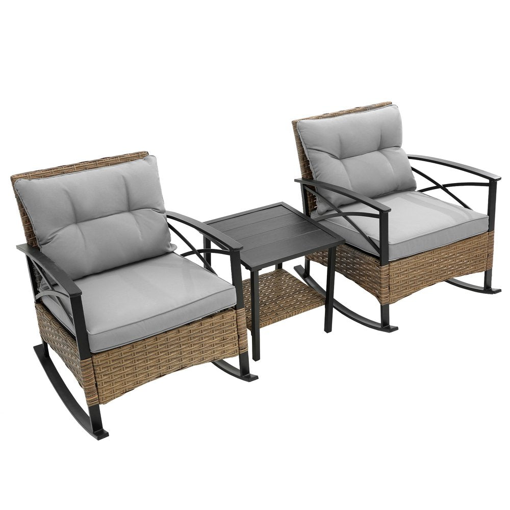 Two gray upholstered rocking chairs and a black slat-top side table with a lower shelf, all with rattan bases, on a white background.