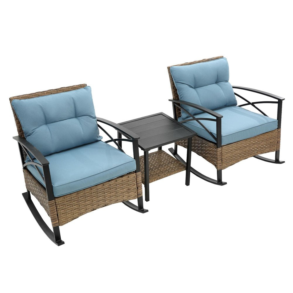 Two light blue cushioned rattan rocking chairs with a black slatted side table on a white background.