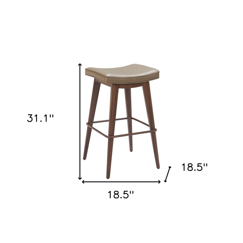 A taupe faux leather and walnut backless bar stool with dimensions 31.1" H x 18.5" W x 18.5" D on a white background.