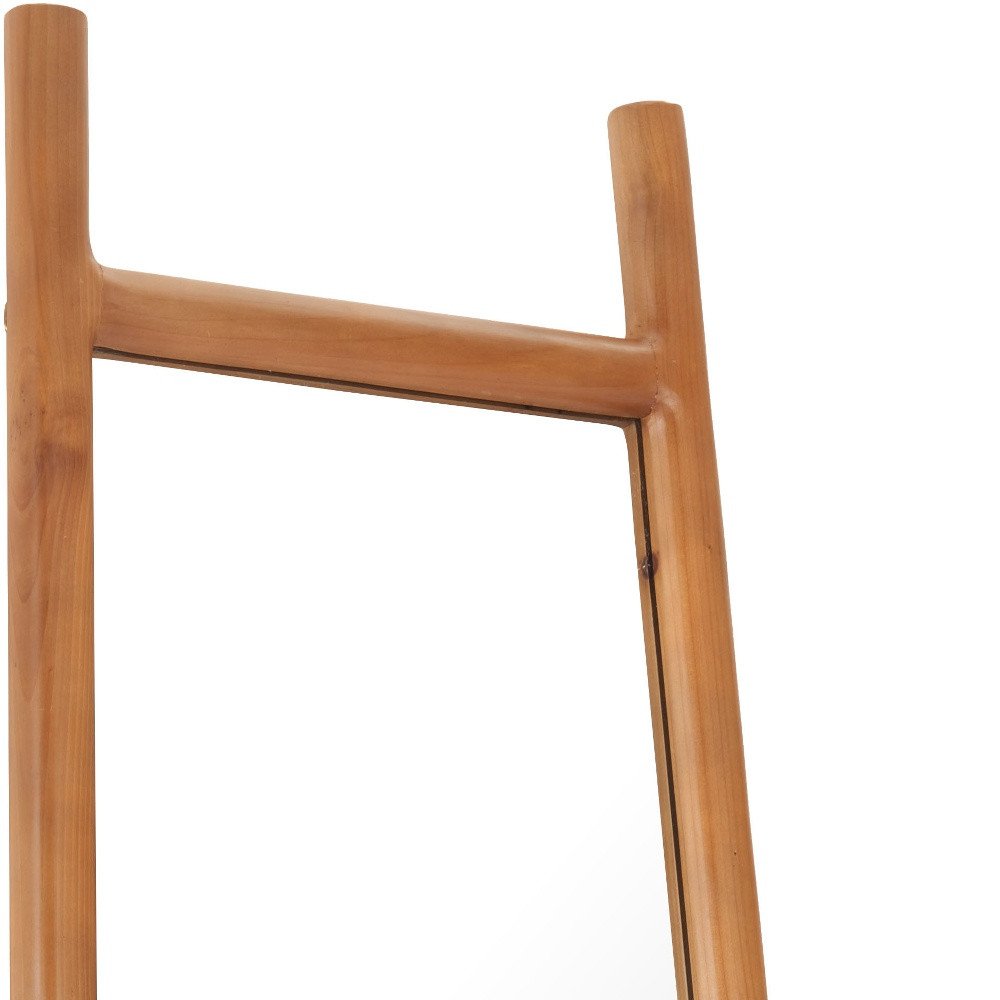 Close-up of a natural solid wood leaning mirror frame with a white background.