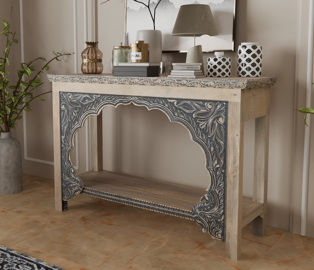 56" Natural and Black Solid Wood Distressed Console Table With Shelf styled in a furnished interior with a tan wall on a wood floor.