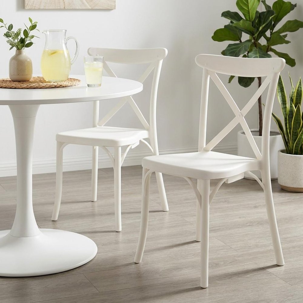 Set of Two White Heavy Duty Plastic Outdoor Stacking Dining Chairs in a home interior
