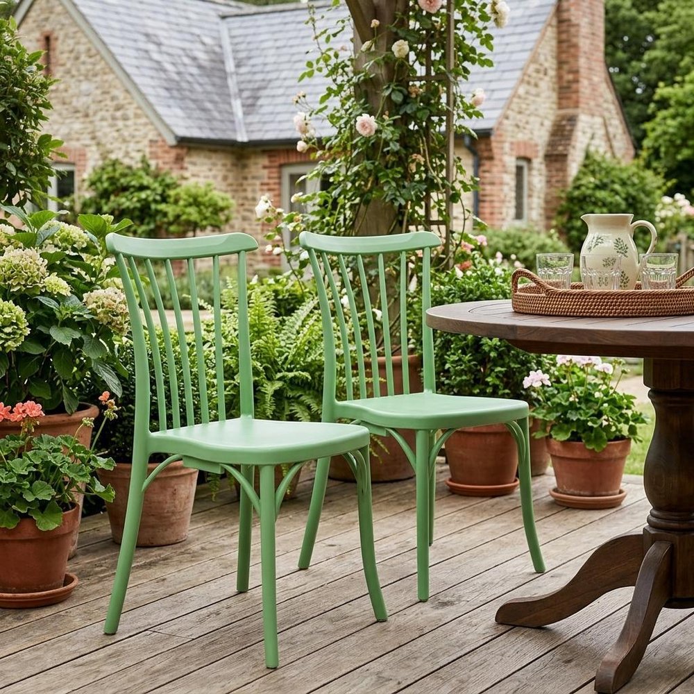 Set of Two Green Heavy Duty Plastic Outdoor Stacking Dining Chairs in a home interior