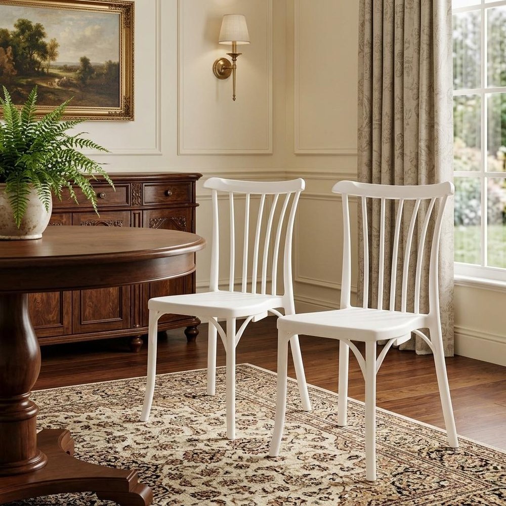 Set of Two White Heavy Duty Plastic Outdoor Stacking Dining Chairs in a home interior