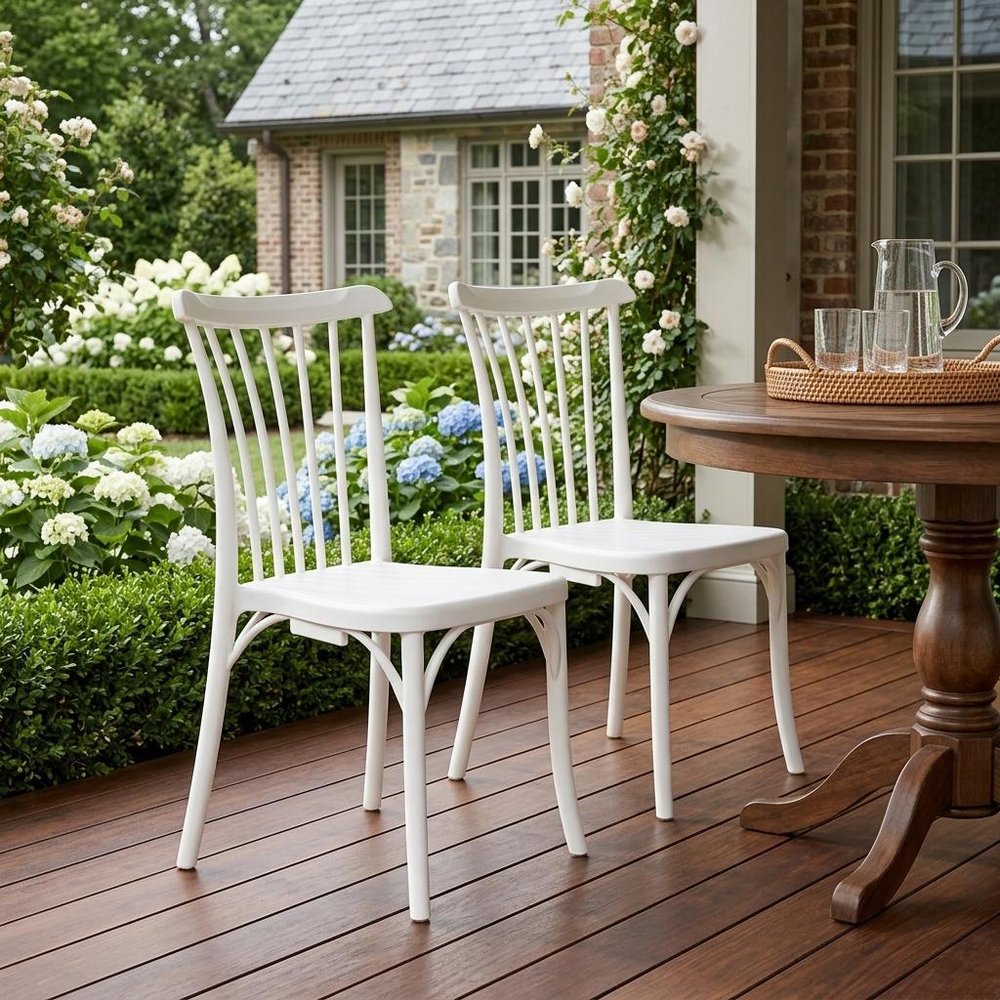 Set of Two White Heavy Duty Plastic Outdoor Stacking Dining Chairs in a home interior