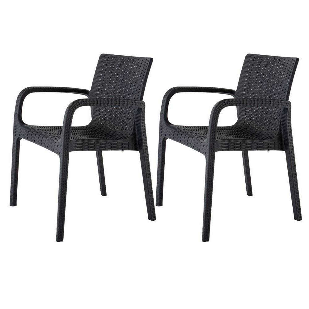 Set of Two Black Faux Rattan Heavy Duty Plastic Outdoor Stacking Arm Chairs on a white background