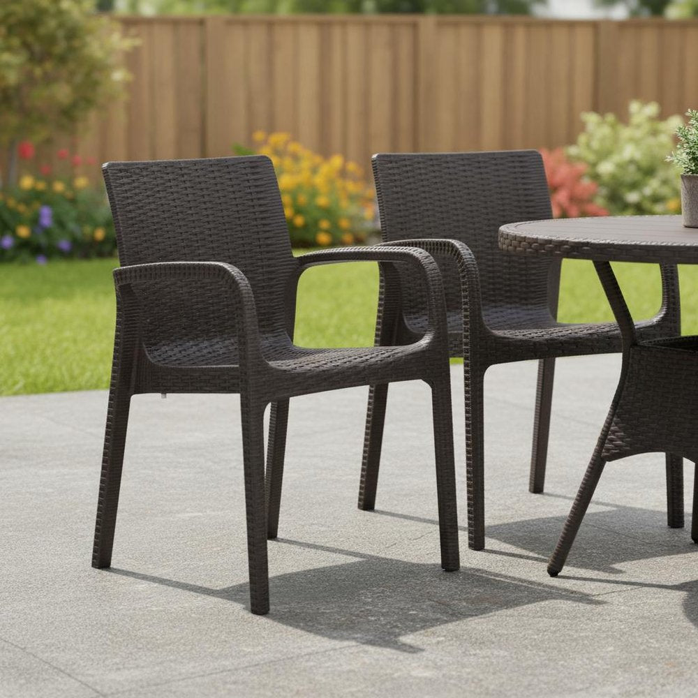 Set of Two Brown Faux Rattan Heavy Duty Plastic Outdoor Stacking Arm Chairs in a home interior