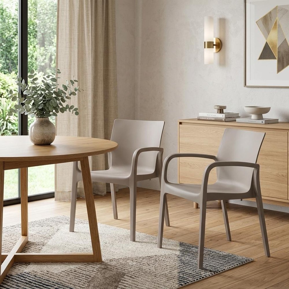 Set of Two Taupe Heavy Duty Plastic Outdoor Stacking Dining Chairs in a home interior