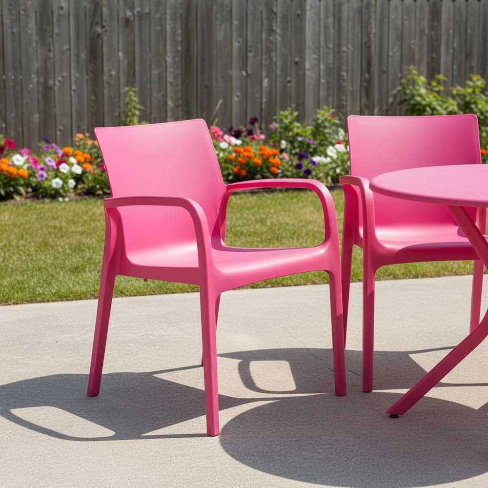 Set of Two Fuchsia Heavy Duty Plastic Outdoor Stacking Dining Chairs in a home interior