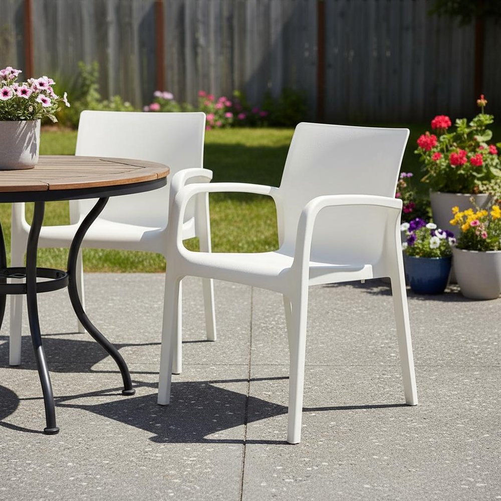 Set of Two White Heavy Duty Plastic Outdoor Stacking Dining Chairs in a home interior