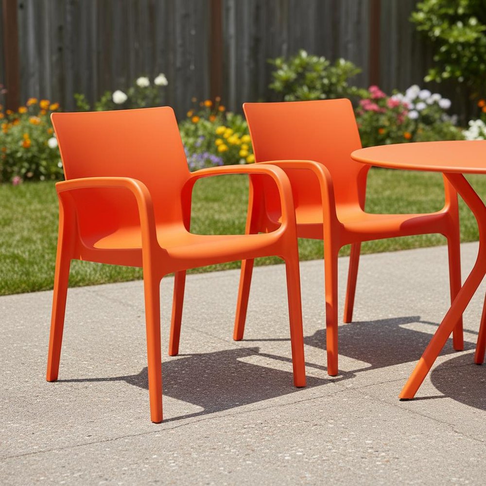 Set of Two Orange Heavy Duty Plastic Outdoor Stacking Dining Chairs in a home interior