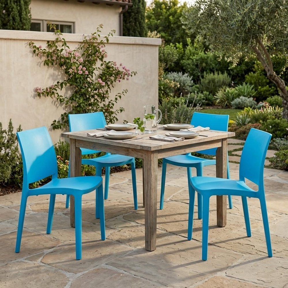 Set of Four Blue Heavy Duty Plastic Outdoor Stacking Dining Chairs in a home interior