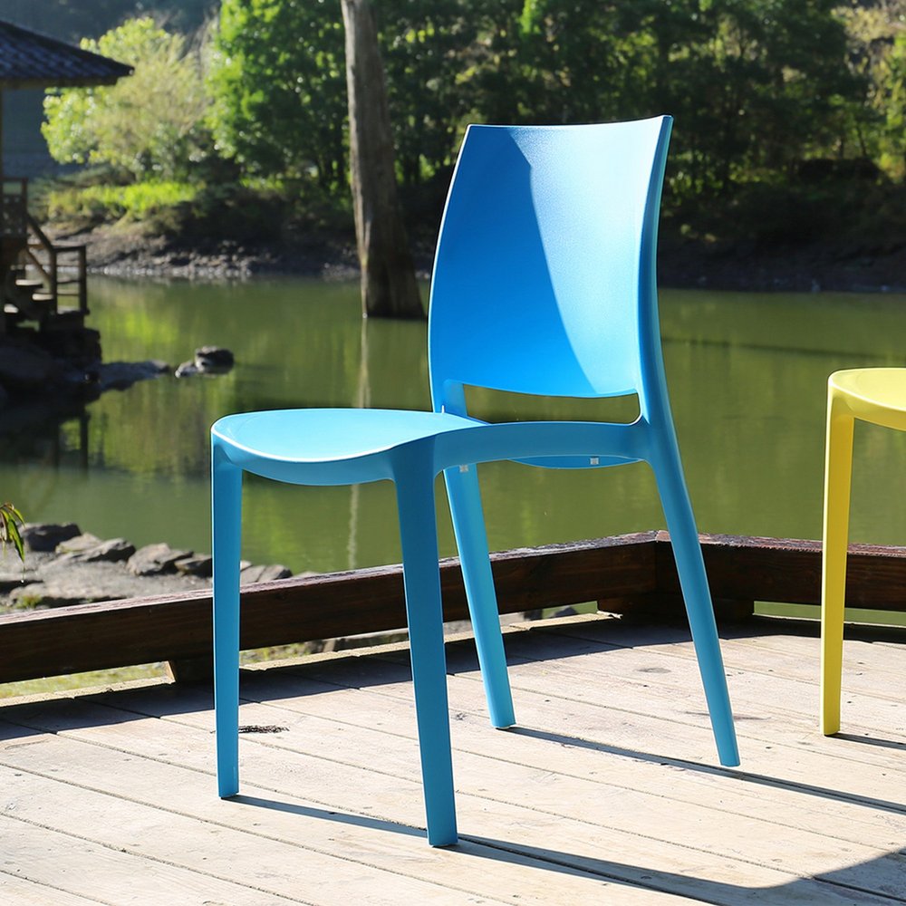 Set of Four Blue Heavy Duty Plastic Outdoor Stacking Dining Chairs in a home interior